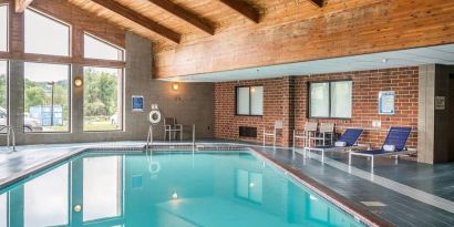 Indoor pool with pool loungers at EnVision Hotel St. Paul South.