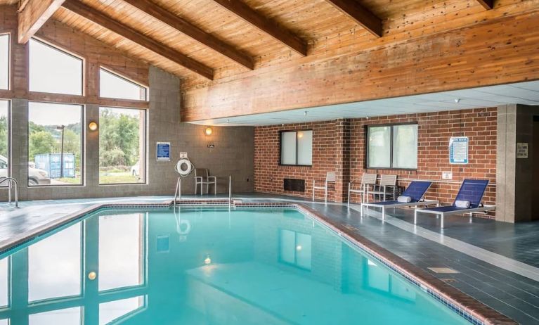 Indoor pool with pool loungers at EnVision Hotel St. Paul South.