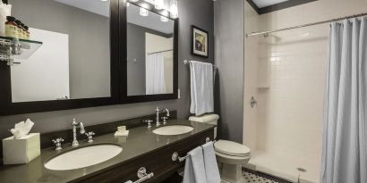 Guest bathroom with shower at EnVision Hotel St. Paul South.