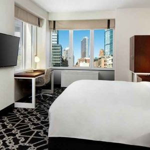 King bed with TV and natural light at Hilton Brooklyn New York.