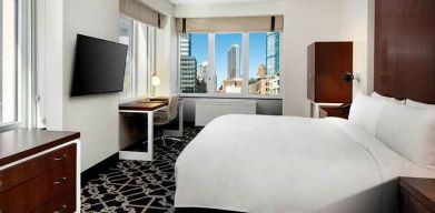 King bed with TV and natural light at Hilton Brooklyn New York.