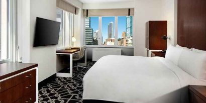 King bed with TV and natural light at Hilton Brooklyn New York.