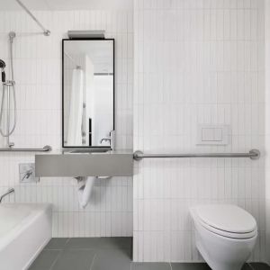 Guest bathroom with shower and bath at Arlo SoHo.
