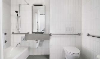 Guest bathroom with shower and bath at Arlo SoHo.
