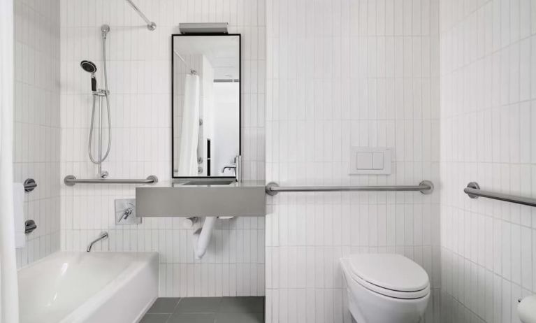 Guest bathroom with shower and bath at Arlo SoHo.
