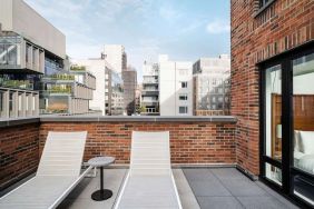 Outdoor terrace with lounge chairs at Arlo SoHo.
