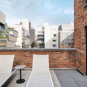 Outdoor terrace with lounge chairs at Arlo SoHo.
