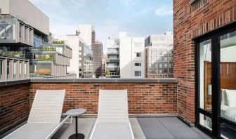 Outdoor terrace with lounge chairs at Arlo SoHo.
