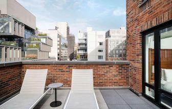 Outdoor terrace with lounge chairs at Arlo SoHo.
