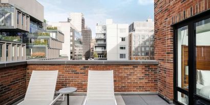 Outdoor terrace with lounge chairs at Arlo SoHo.
