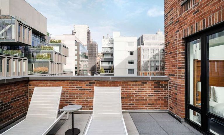 Outdoor terrace with lounge chairs at Arlo SoHo.
