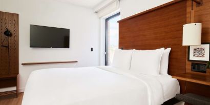 King bed with TV at Arlo SoHo.