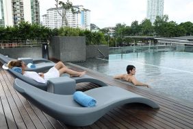 Stunning outdoor pool with lounge chairs at Capri By Fraser Johor Bahru.