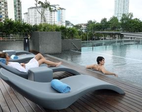 Stunning outdoor pool with lounge chairs at Capri By Fraser Johor Bahru.