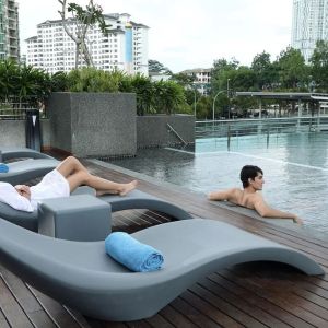 Stunning outdoor pool with lounge chairs at Capri By Fraser Johor Bahru.