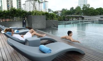 Stunning outdoor pool with lounge chairs at Capri By Fraser Johor Bahru.