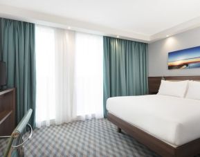 King room with TV and work station at Hampton By Hilton London Stansted Airport.