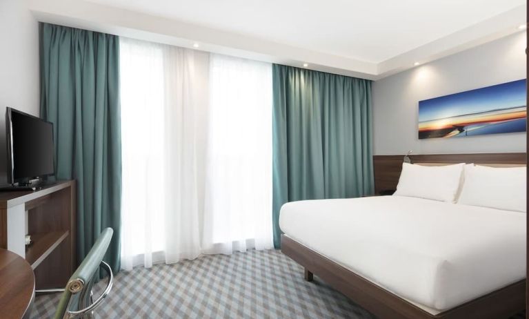 King room with TV and work station at Hampton By Hilton London Stansted Airport.