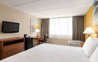 Day use room with TV and work space at Days Inn Miami International Airport,