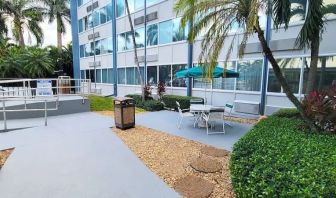 Outdoor garden and terrace at EnVision Hotel Miami International Airport.