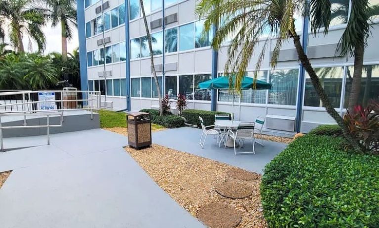 Outdoor garden and terrace at EnVision Hotel Miami International Airport.