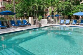 Large outdoor pool with sun lounge chairs at Sonesta ES Suites Fort Lauderdale Plantation.