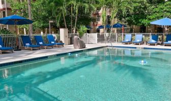 Large outdoor pool with sun lounge chairs at Sonesta ES Suites Fort Lauderdale Plantation.