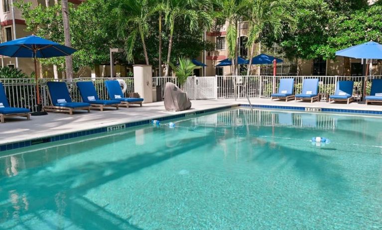 Large outdoor pool with sun lounge chairs at Sonesta ES Suites Fort Lauderdale Plantation.