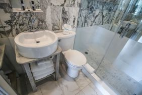 Guest bathroom with shower at Chesterfield Hotel & Suites.