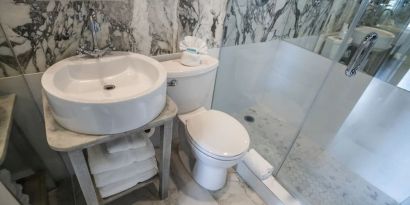 Guest bathroom with shower at Chesterfield Hotel & Suites.