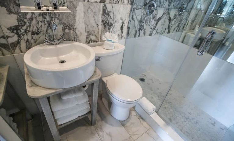 Guest bathroom with shower at Chesterfield Hotel & Suites.