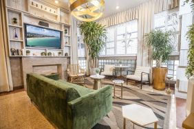 Lobby and lounge area with TV at Chesterfield Hotel & Suites.