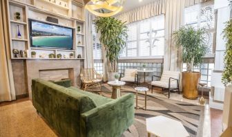 Lobby and lounge area with TV at Chesterfield Hotel & Suites.