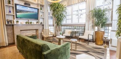 Lobby and lounge area with TV at Chesterfield Hotel & Suites.