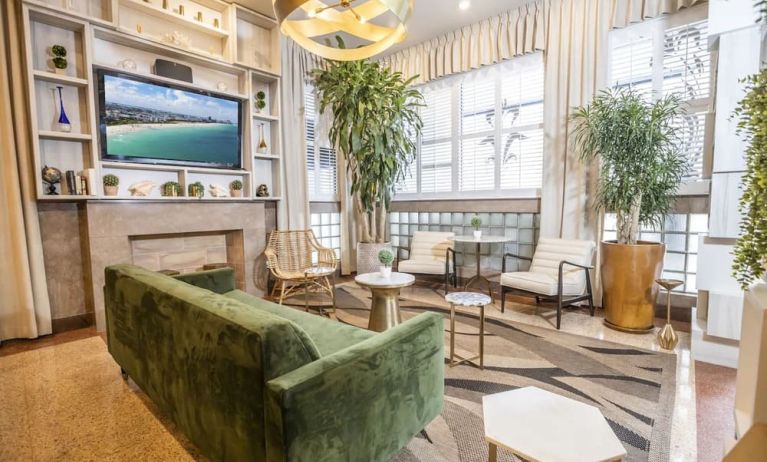 Lobby and lounge area with TV at Chesterfield Hotel & Suites.