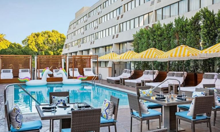 Outdoor pool with surrounding seating area at Hotel Dena, Pasadena Los Angeles.