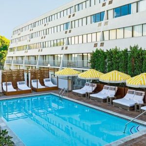 Relaxing outdoor pool with pool loungers at Hotel Dena, Pasadena Los Angeles.