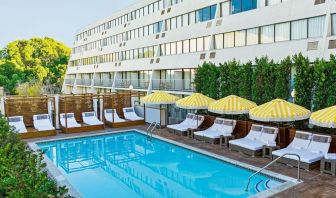 Relaxing outdoor pool with pool loungers at Hotel Dena, Pasadena Los Angeles.