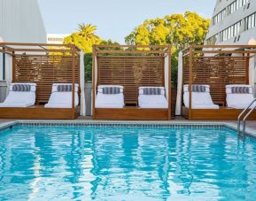 Pool cabanas and pool chairs at Hotel Dena, Pasadena Los Angeles.