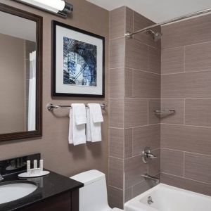 Guest bathroom with shower and bath at Fairfield Inn & Suites By Marriott New York Staten Island.