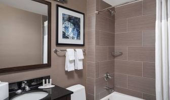 Guest bathroom with shower and bath at Fairfield Inn & Suites By Marriott New York Staten Island.