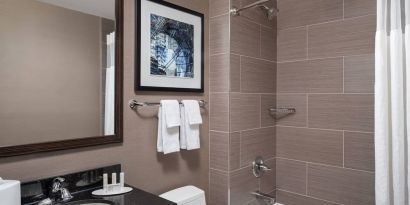 Guest bathroom with shower and bath at Fairfield Inn & Suites By Marriott New York Staten Island.