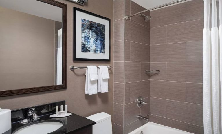 Guest bathroom with shower and bath at Fairfield Inn & Suites By Marriott New York Staten Island.