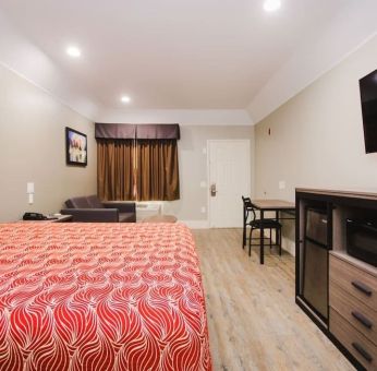 King bed with TV and work space at Palace Inn I-10 West & Beltway 8.