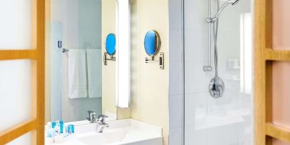 Guest bathroom with shower at Novotel Toronto North York.