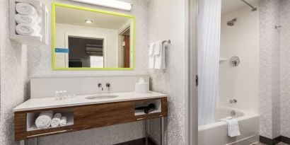 Guest bathroom with shower at Hampton Inn & Suites Miami Kendall. 