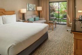 Bright king bedroom with large window overlooking the patio at the DoubleTree by Hilton Sonoma Wine Country.