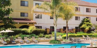 Relaxing pool area with lounges at the DoubleTree by Hilton Sonoma Wine Country.