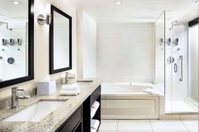 Guest bathroom with shower and bath at Four Points By Sheraton Mississauga Meadowvale.