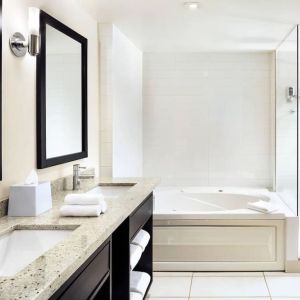 Guest bathroom with shower and bath at Four Points By Sheraton Mississauga Meadowvale.